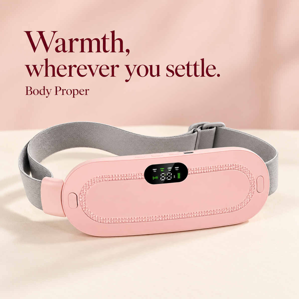 Body Proper pink wearable heating belt with adjustable grey strap